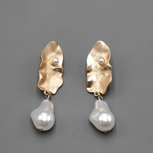 Gold tone baroque pearl dangling earrings